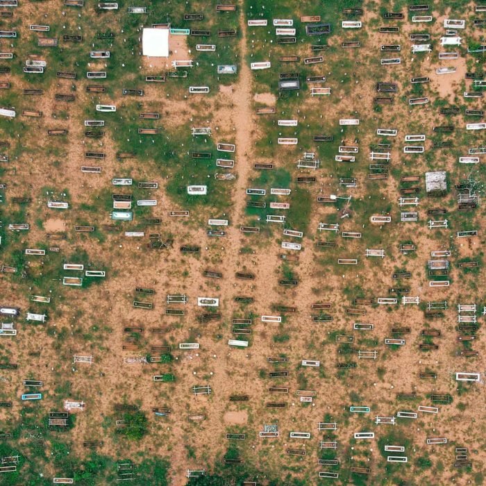 Top view of small trailers and shabby houses in poor suburbs of countryside on sandy terrain in daytime